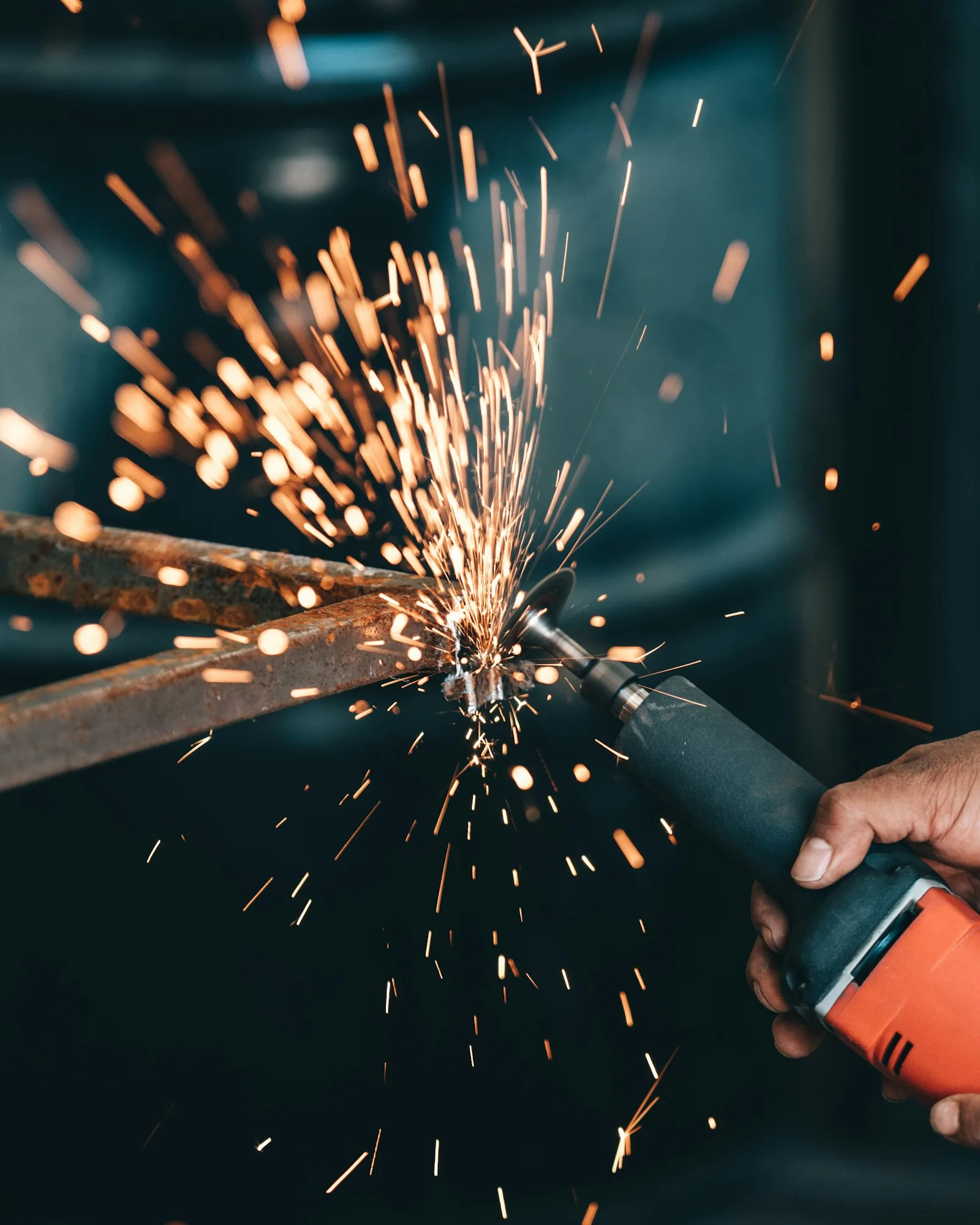 Angle grinder finishing a structural steel beam